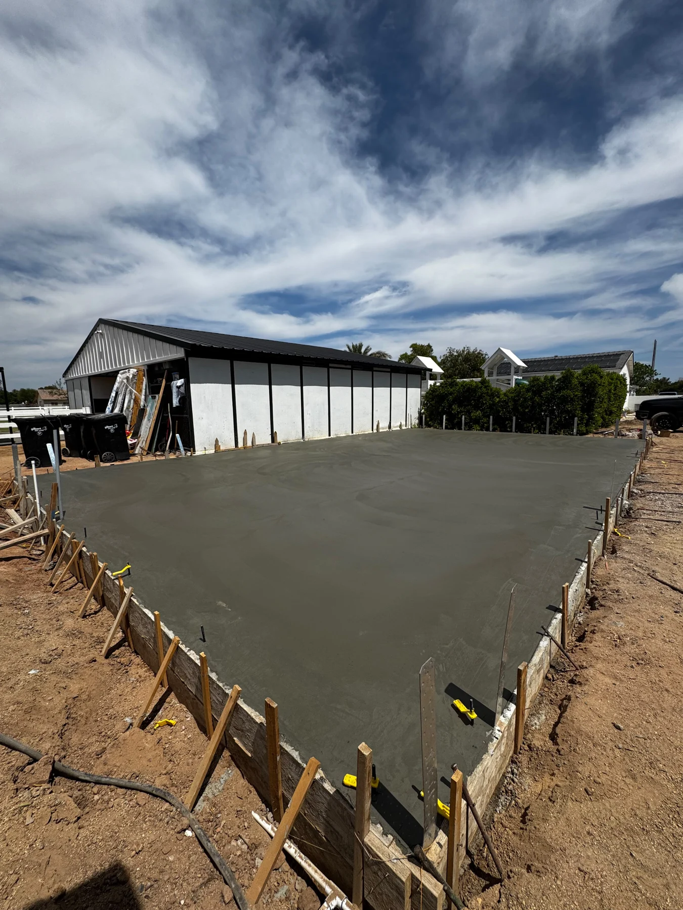 Large newly finished concrete slab behind a residential home